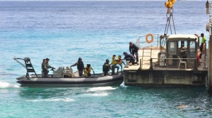 Suspected asylum seekers arrive on Christmas Island, after being intercepted by the Australian Navy, on August 3, 2013.