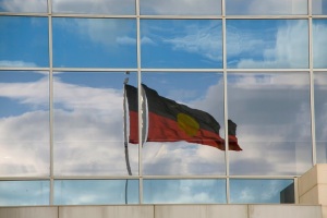 Aboriginal flag reflected in building window